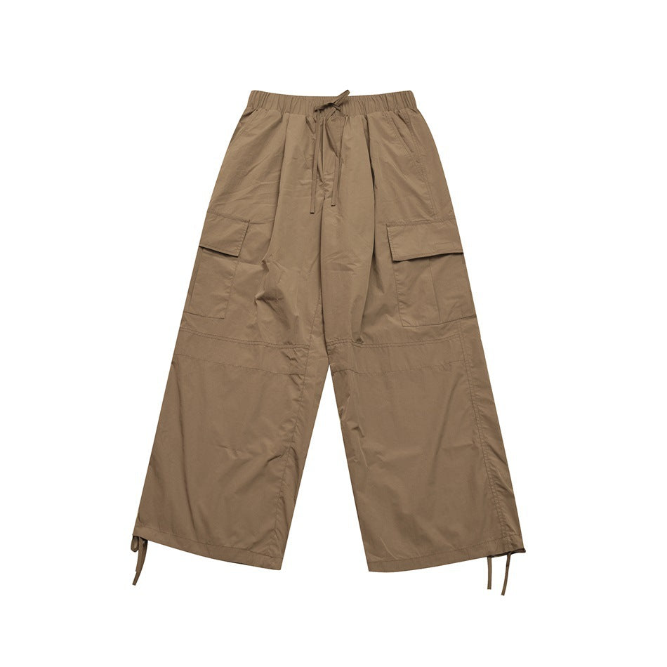Khaki wide-leg cargo pants flat lay with elastic drawstring waist, flap thigh pockets and hem drawcords
