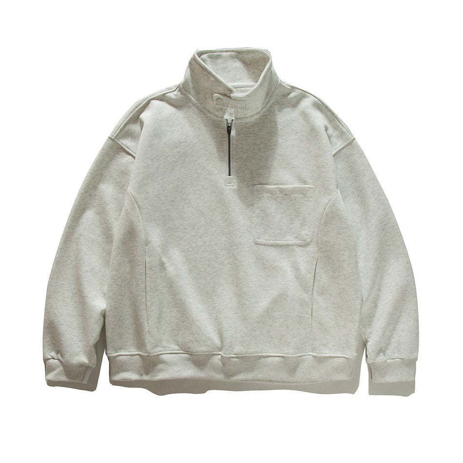 Heather gray half-zip stand-collar sweatshirt flat lay with chest pocket and ribbed cuffs and hem