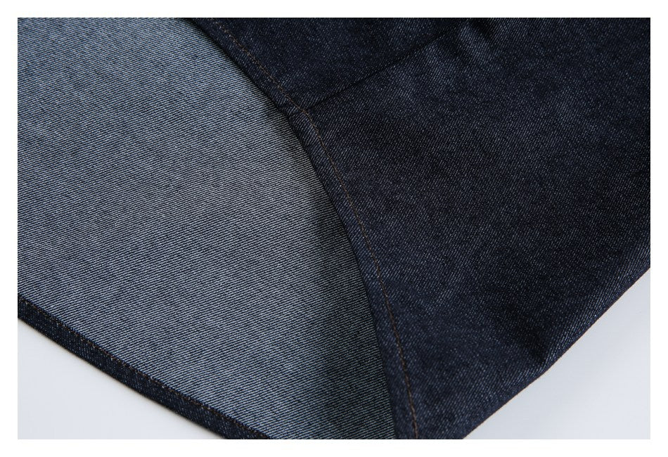 Close-up showing a curved seam between dark indigo denim and its lighter reverse side.