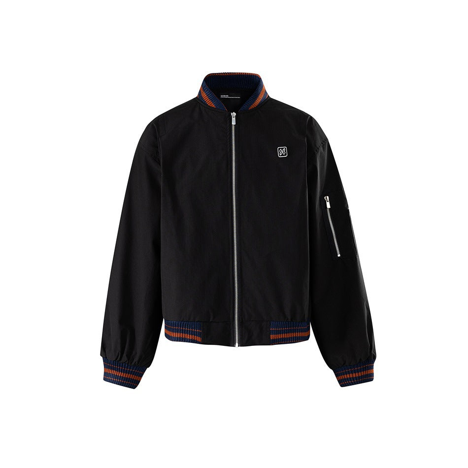 Black bomber jacket with navy and orange striped ribbed collar, cuffs and hem, front zip and sleeve zip pocket