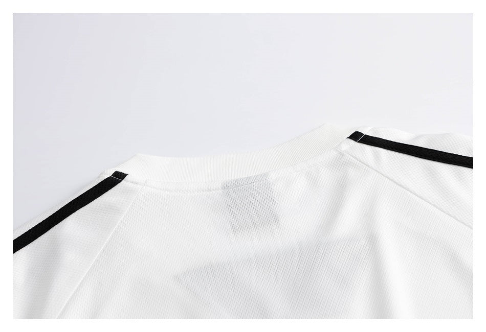 Close-up of a white jersey's back collar and shoulders with black shoulder stripes.