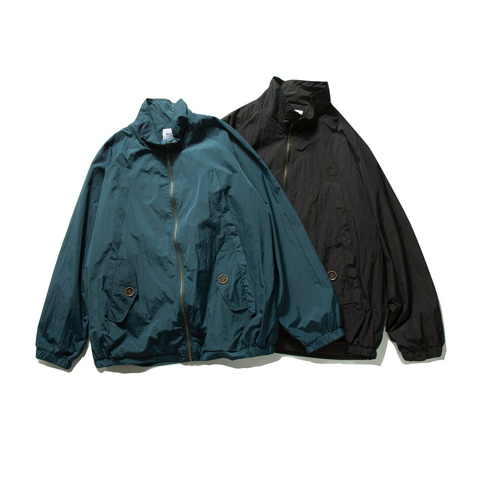 Two full front views of zip-up jackets with tall collars and flap pockets, in teal and black.