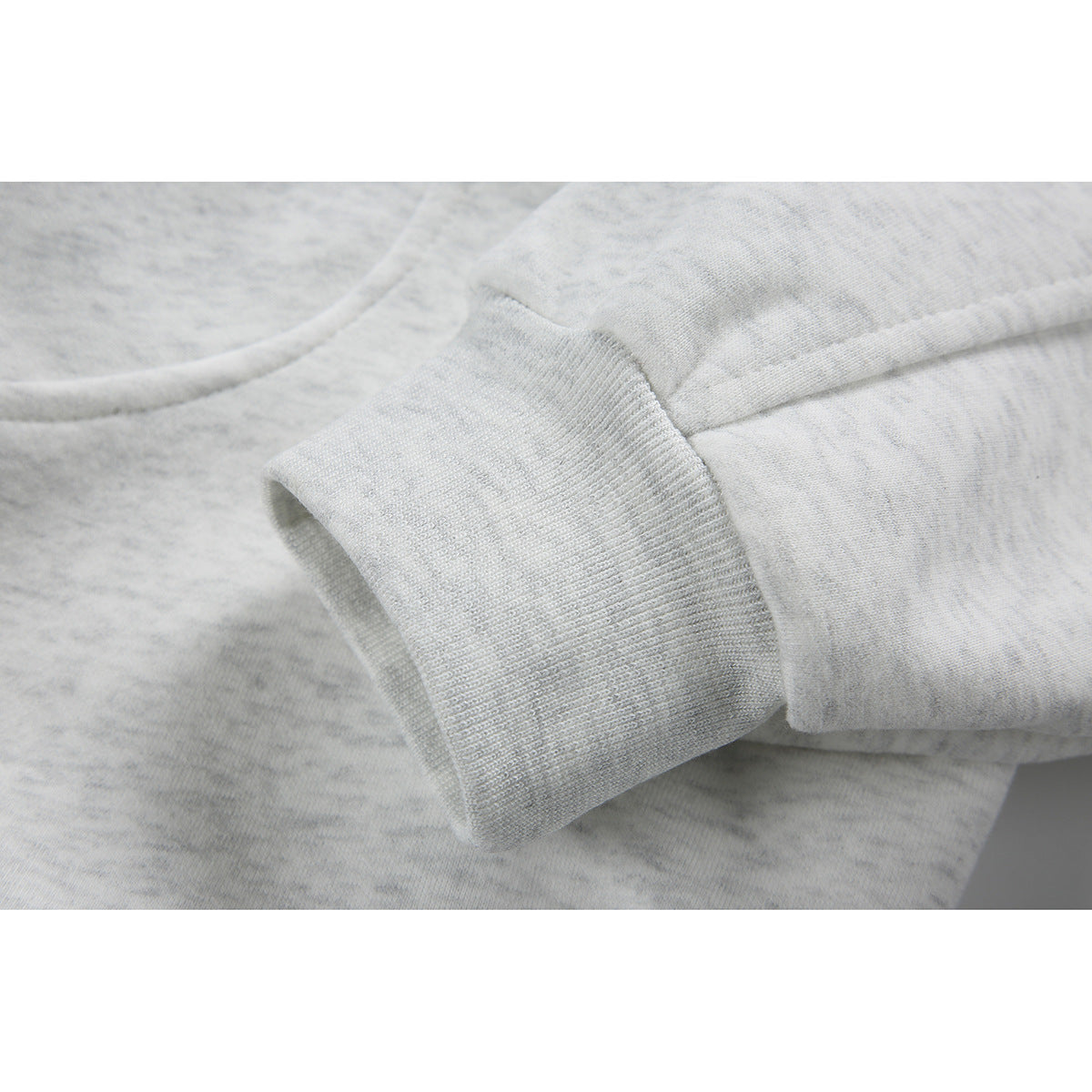 Close-up of a light gray jacket sleeve and wide ribbed cuff.