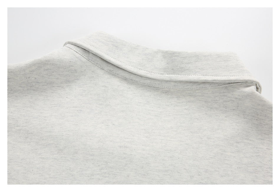 Close-up of the light heather-gray garment's folded collar and neckline.