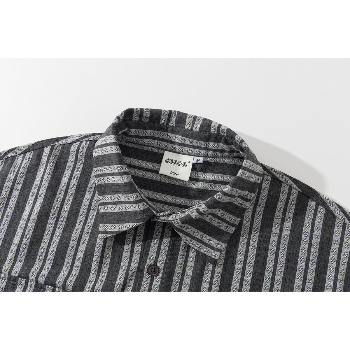 Close-up of a charcoal gray striped shirt collar with diamond motifs, button placket, and neck label.