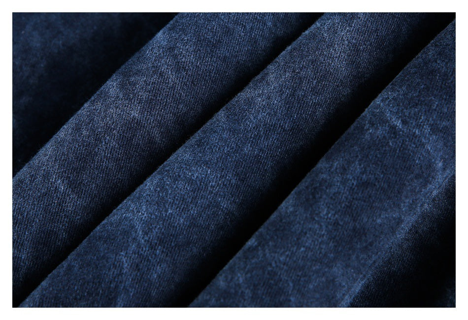 Close-up of the dark blue garment fabric arranged in soft folds.