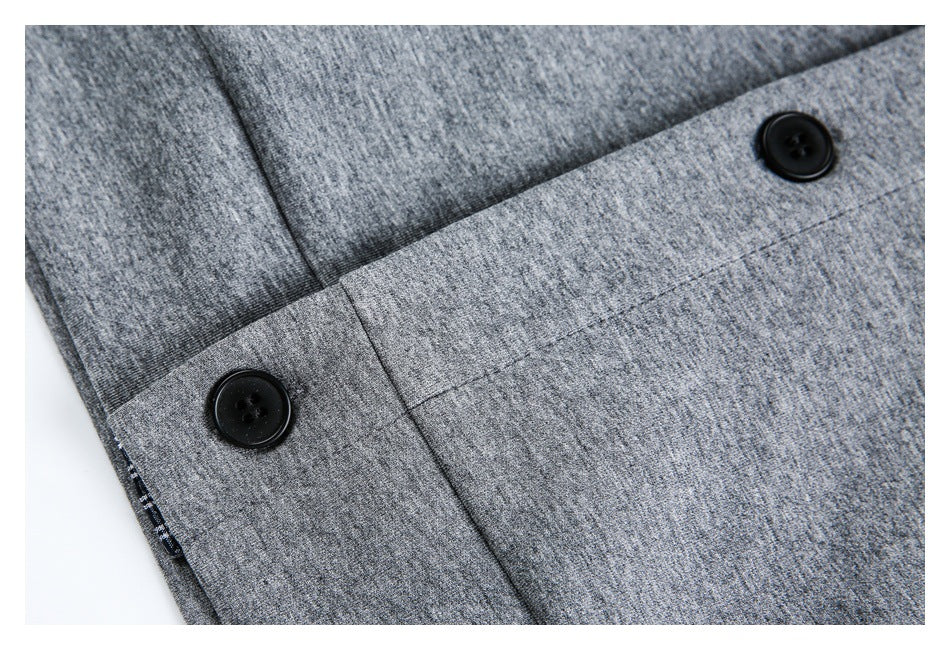Close-up of a gray heathered garment with two black buttons and a stitched front panel.