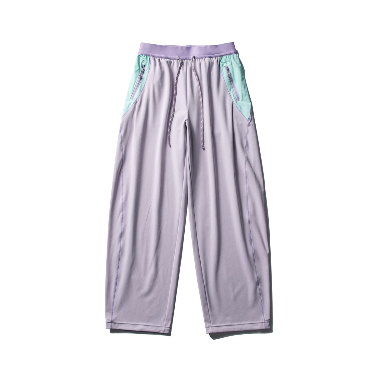 Front view of lavender wide-leg pants with a lilac waistband, mint zip-pocket panels, and a drawstring waist.