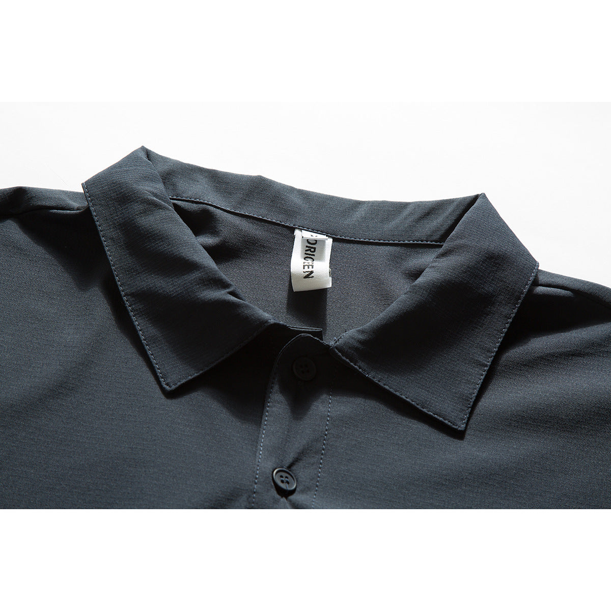 Close-up of a dark charcoal shirt collar, button placket, and sewn-in neck label.