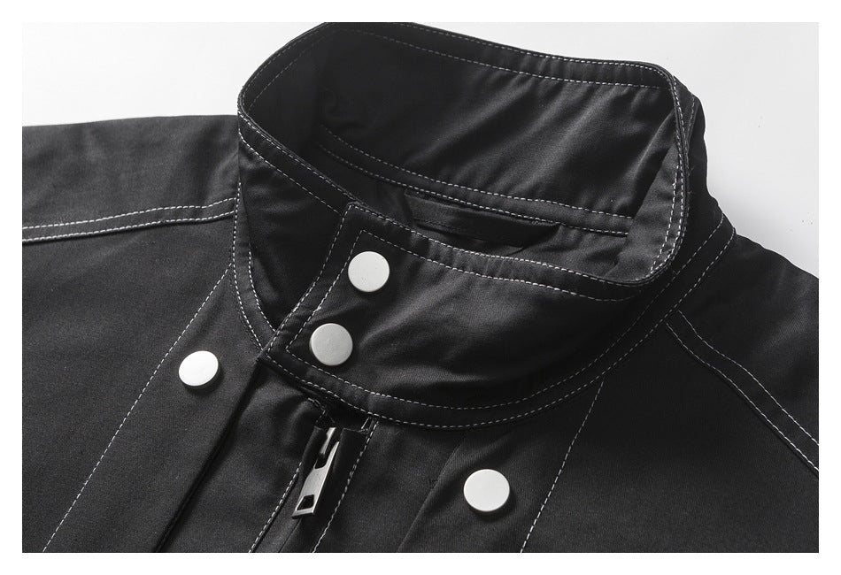Close-up of the black jacket's collar, contrast stitching, silver snaps and zipper.