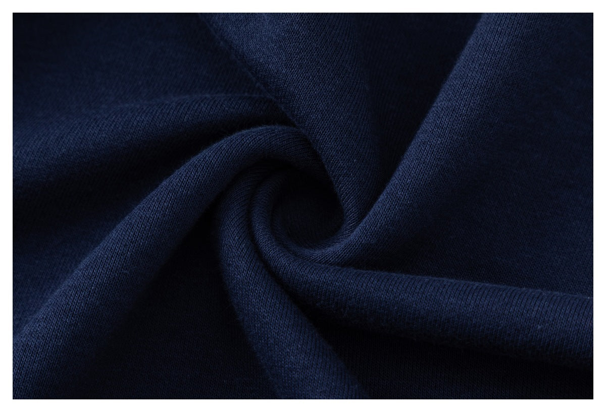 Close-up of dark navy fabric gathered into folds, showing its surface texture.