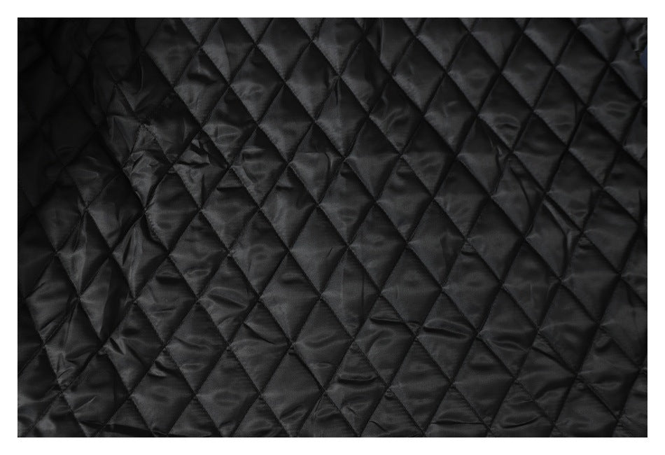 Close-up of black diamond-quilted lining.