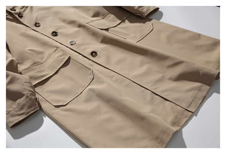 Flat-lay view of a beige button-front coat with large flap pockets and long sleeves.