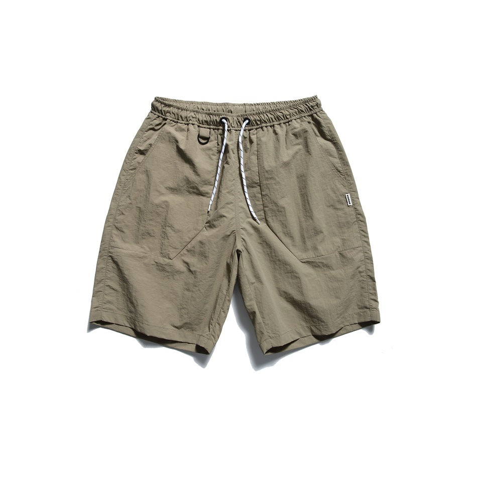 Army green nylon-look drawstring shorts with front pocket panels and a D-ring, flat lay front view