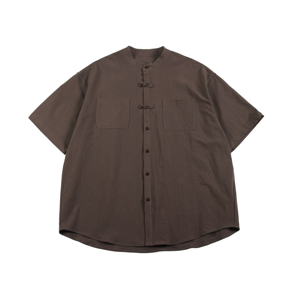 Brown short-sleeve stand-collar shirt with frog closures, buttons and two chest pockets, flat front view
