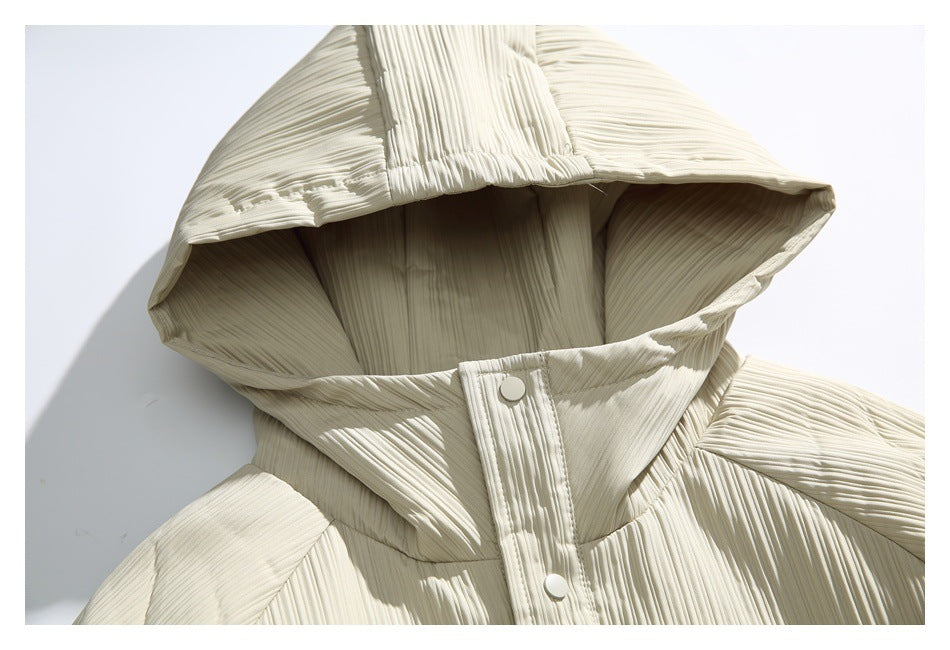 Close-up of an ivory pleated jacket hood and snap-button placket.