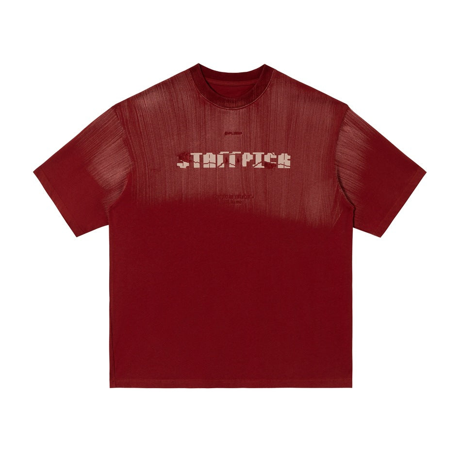 Red short-sleeve crew-neck T-shirt with brushed streak finish and pixel-style logo graphic on the chest, flat lay