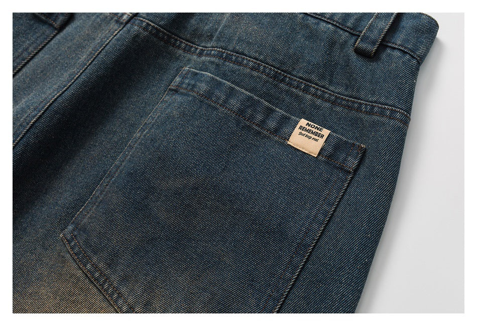 Close-up of a rear pocket on blue faded jeans, with contrast stitching and a small sewn label.