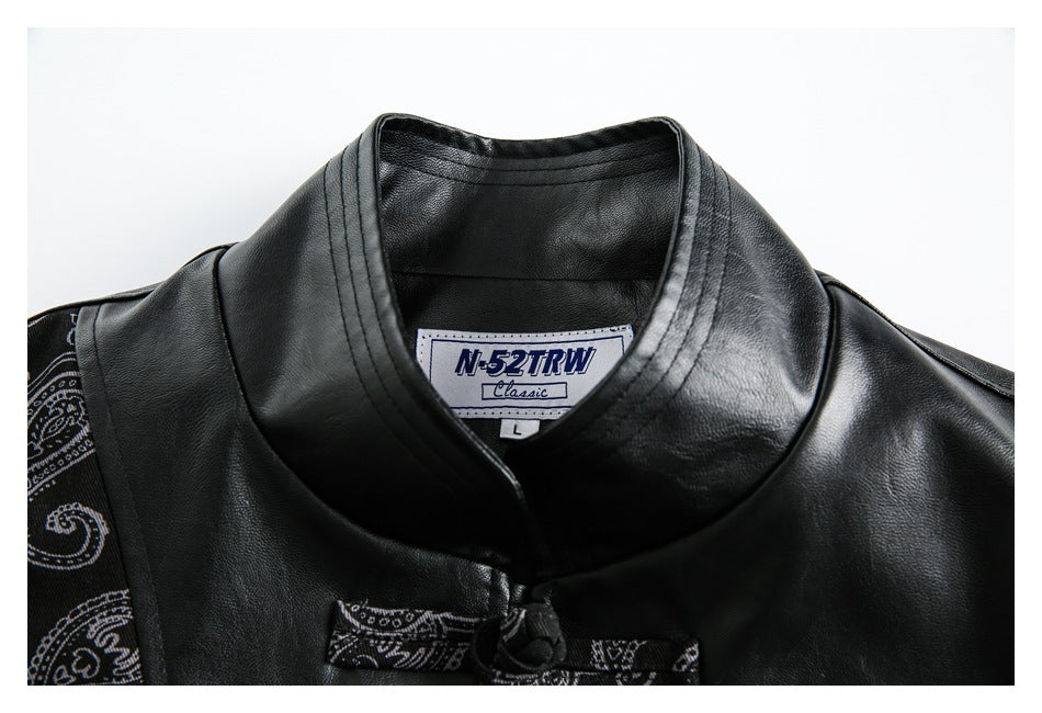 Close-up of the black jacket's stand collar, frog closure, paisley sleeve panel, and sewn-in N-52TRW Classic label.