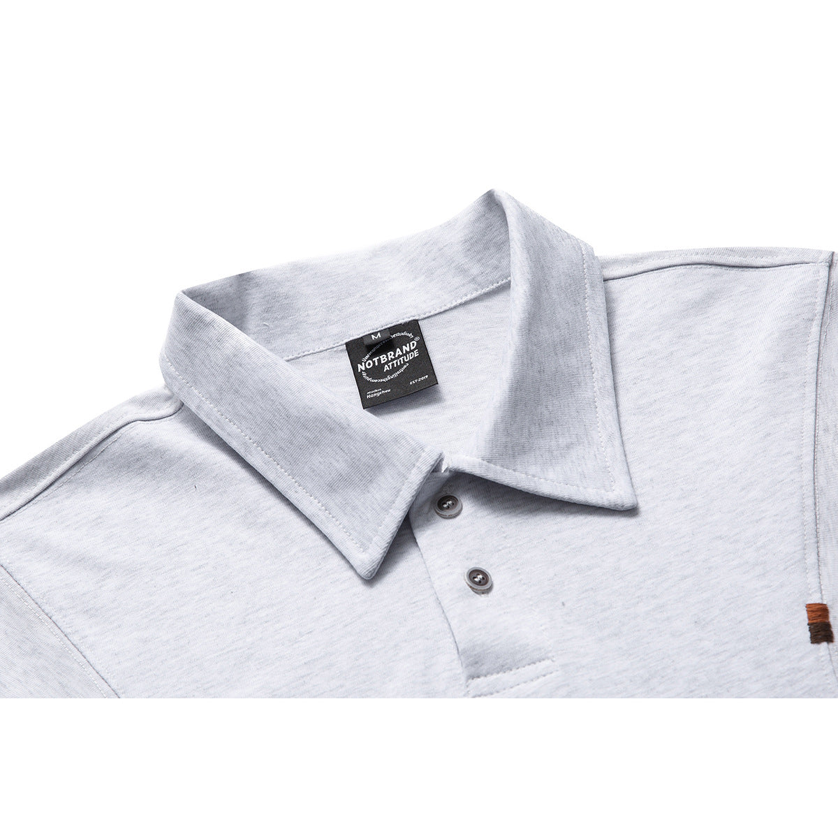 Close-up of a light gray polo shirt collar, two-button placket, and sewn-in black neck label.