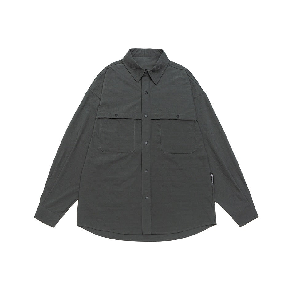 Dark gray long-sleeve snap-front shirt with two chest pockets, flat lay front view
