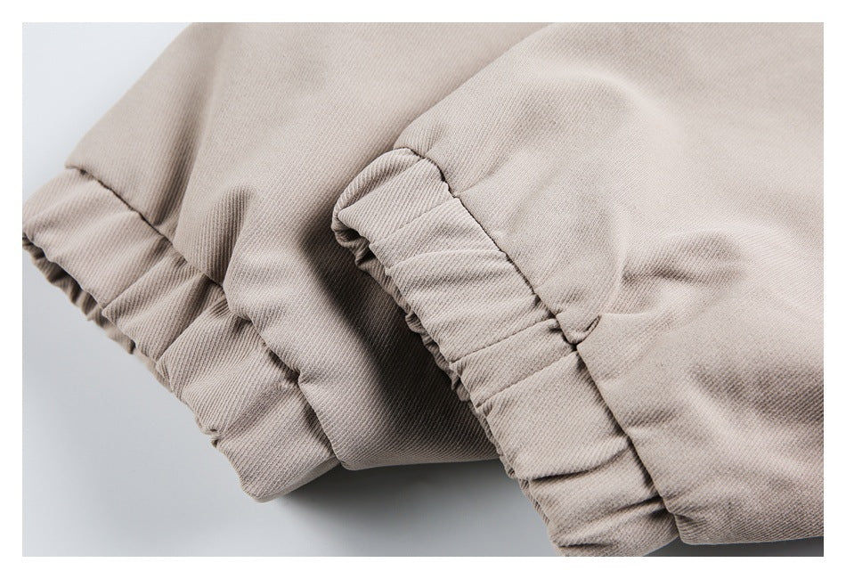 Close-up of gathered, stitched edges on a beige garment.