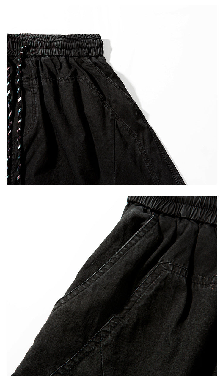 Close-up views of black shorts showing the elastic waistband, drawstring, and angled pocket stitching.
