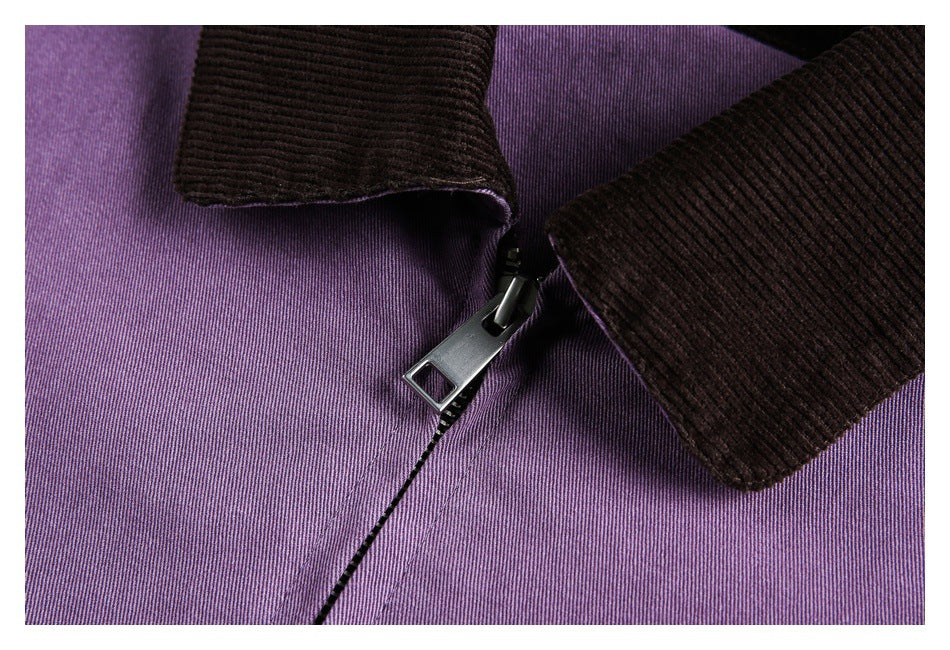 Close-up of a purple jacket's metal zipper beneath a dark ribbed collar.