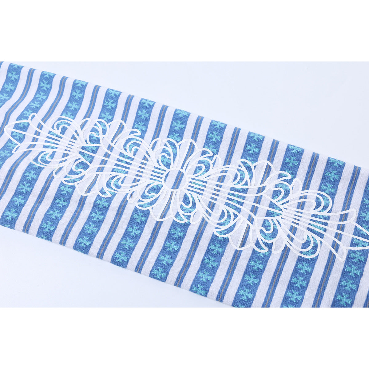 Close-up of a white ornamental graphic across blue, white, and gray striped fabric.