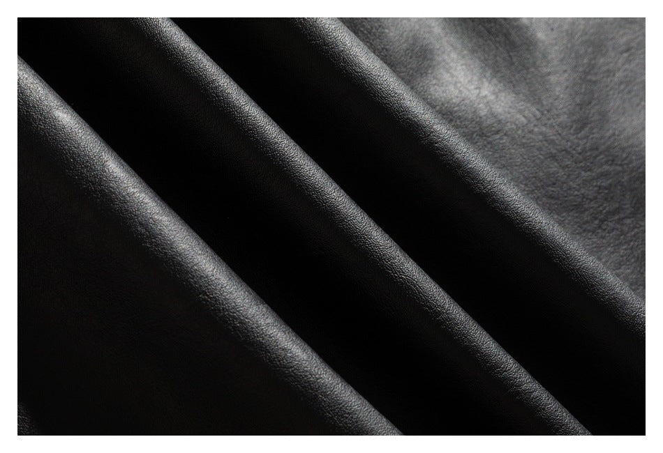Macro view of the pebbled texture and folds of black jacket material.