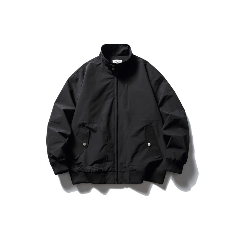 Black stand-collar zip jacket flat lay with snap flap pockets and ribbed cuffs and hem