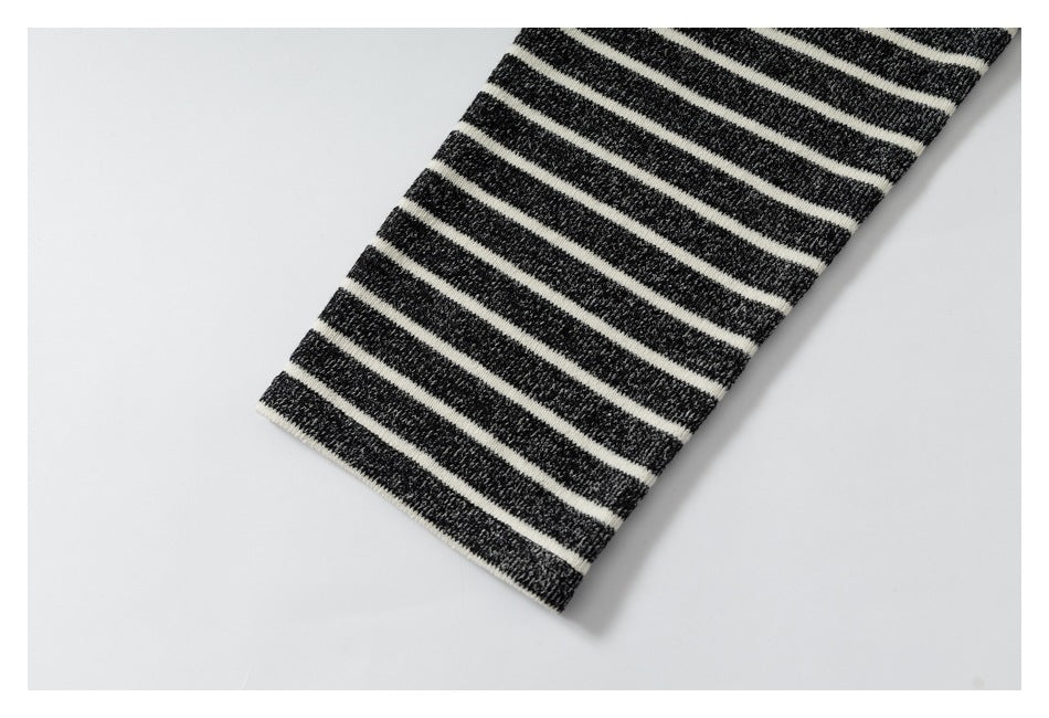 Close-up of a charcoal and cream striped knit sleeve laid diagonally on a white background.