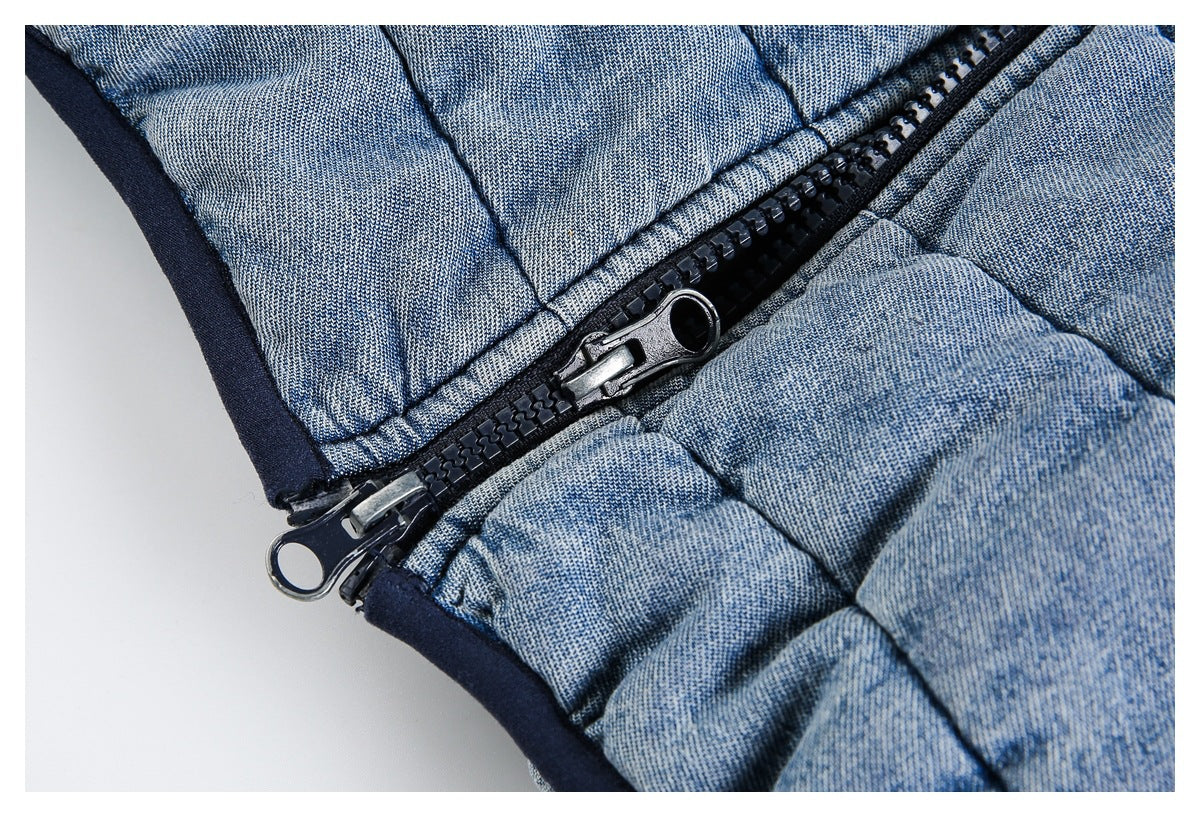 Close-up of a black two-way zipper on the light blue quilted jacket.