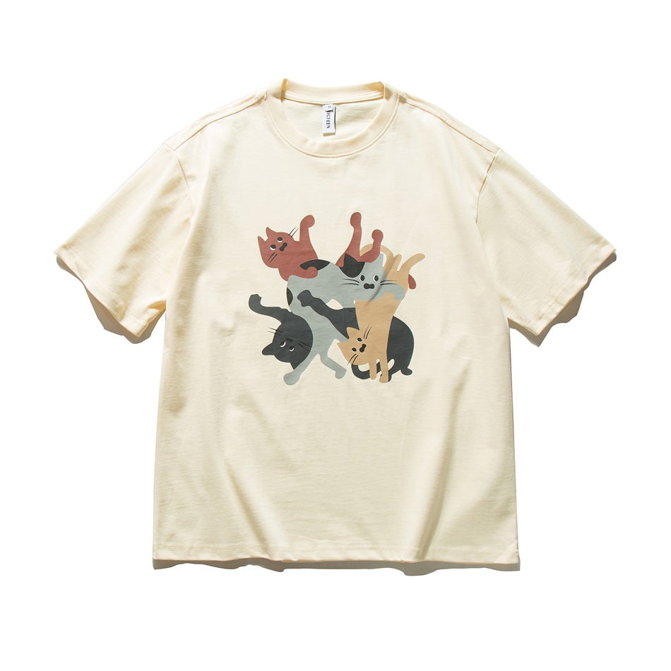 Apricot short-sleeve crew-neck t-shirt with a front print of stacked cartoon cats, flat lay