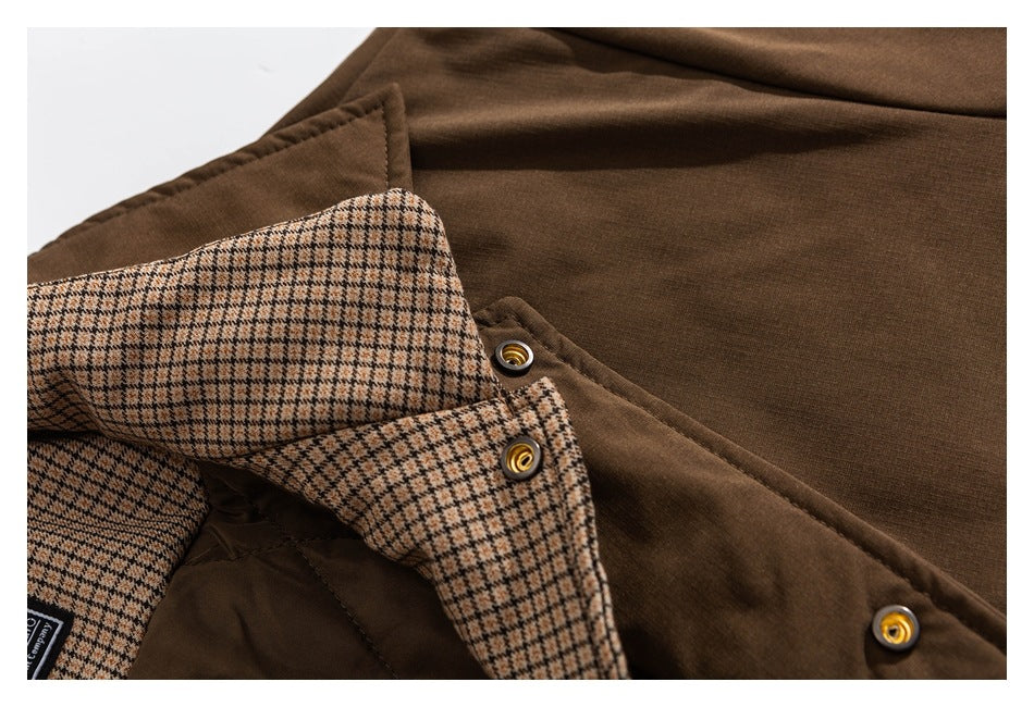 Close-up of the brown jacket's checked lining and snap-fastened front placket.