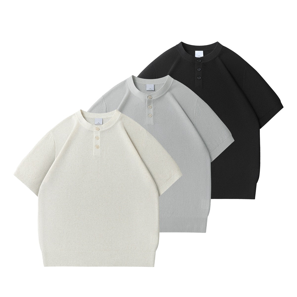 Three short-sleeve knit Henley tops shown from the front in ivory, light gray, and black.