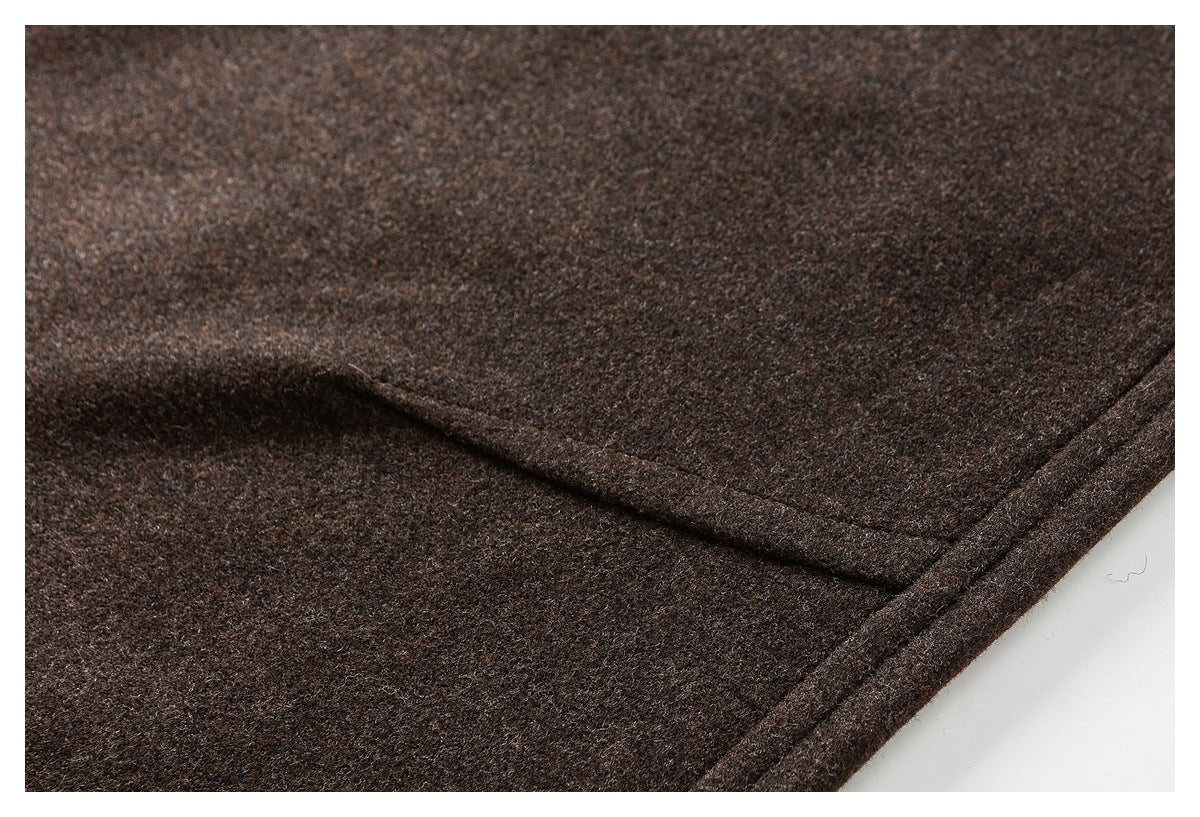 Close-up of dark brown pants fabric and a stitched seam near the edge.