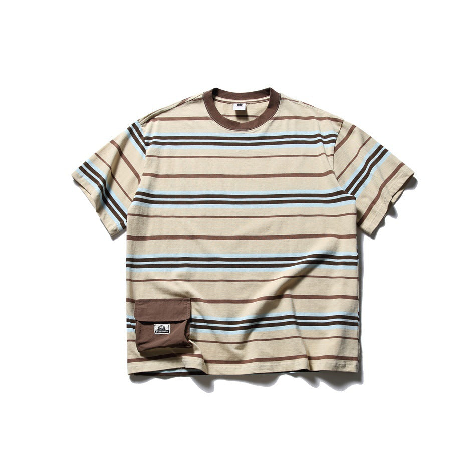 Front view of a beige short-sleeve crew-neck T-shirt with brown and light blue stripes and a brown flap pocket near the hem.