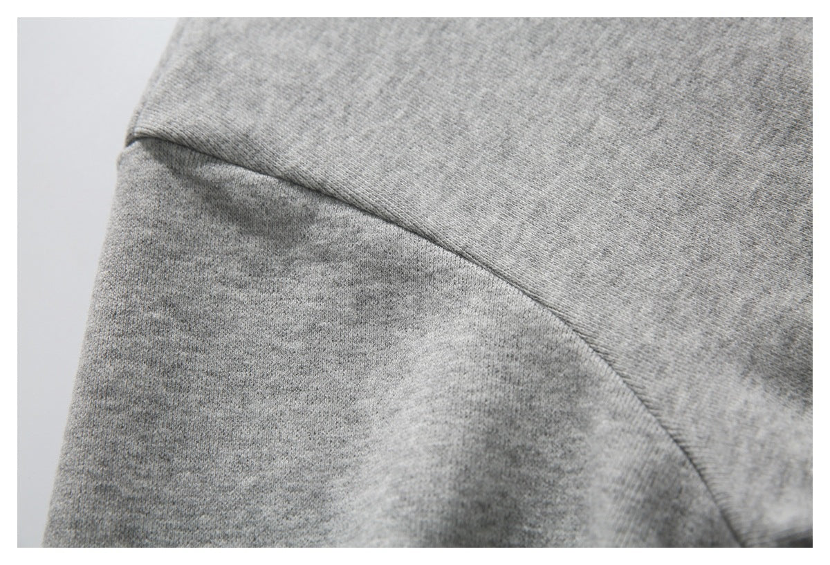Close-up of the light gray hoodie's sleeve and shoulder seam.