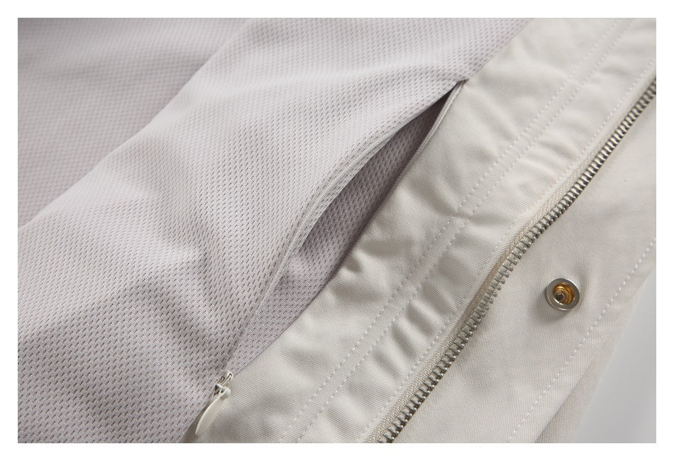 Close-up of the jacket's gray mesh lining beside an ivory zipper and metal snap.