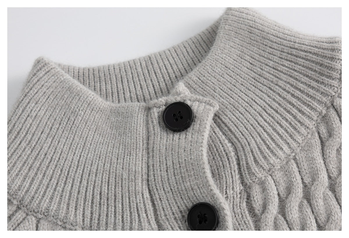 Close-up of the ribbed collar and black buttons on a light gray cable-knit cardigan.