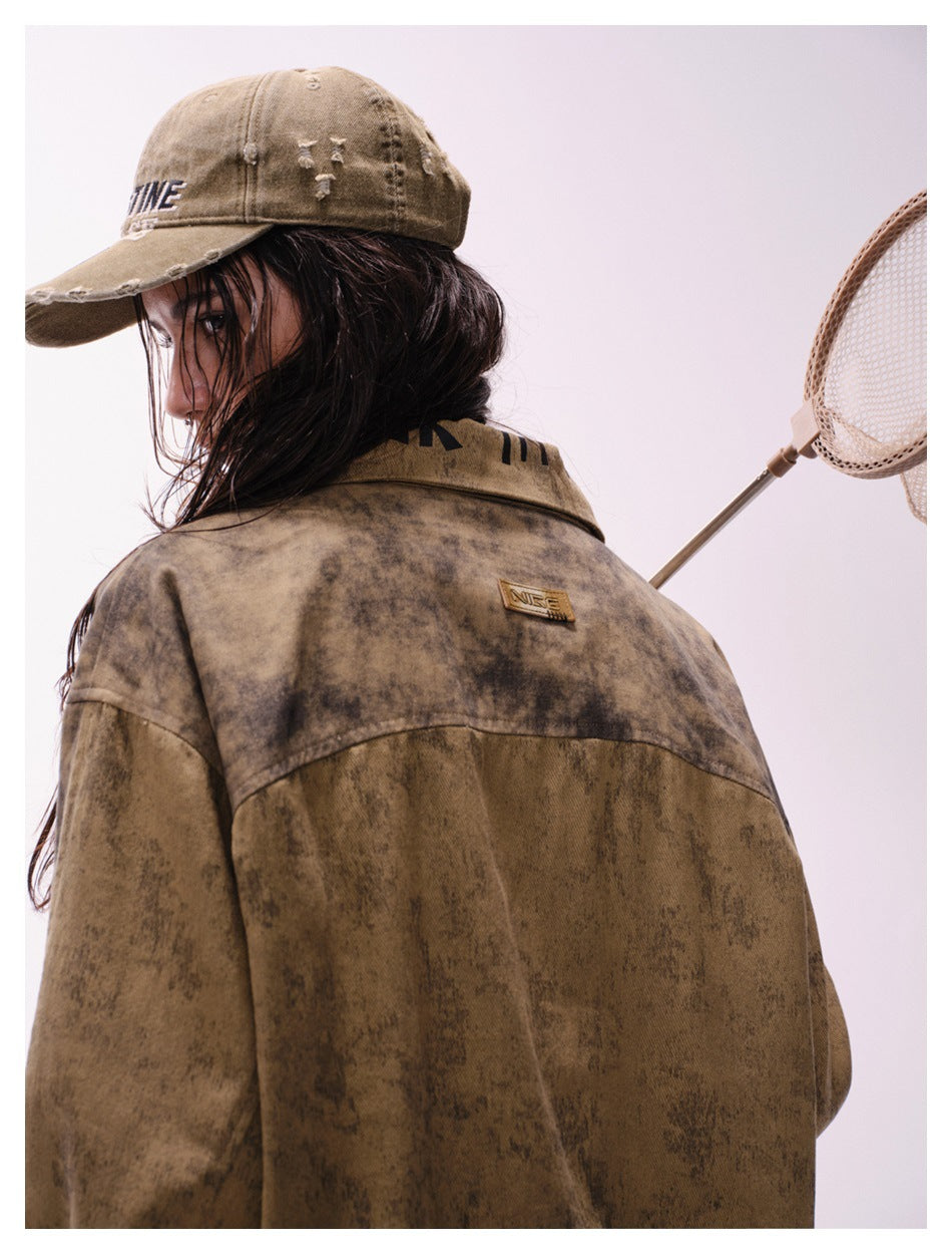 Model wearing a distressed tan cap and mottled brown jacket, shown from behind with a small patch on the upper back.