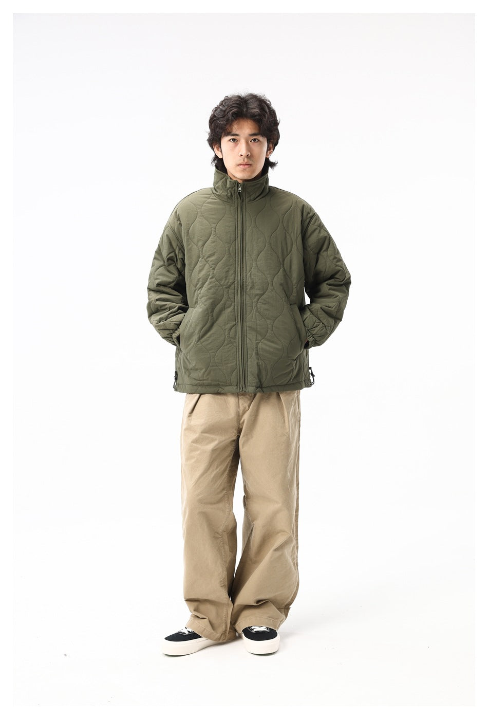 Model wearing army green quilted zip jacket with khaki wide-leg pants, front view