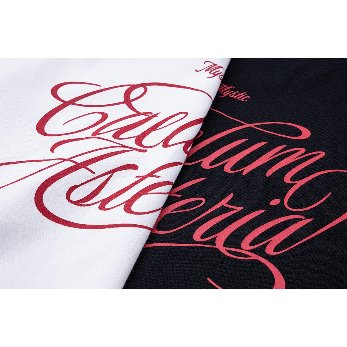 Close-up of large red script graphics printed on white and black T-shirt fabric.