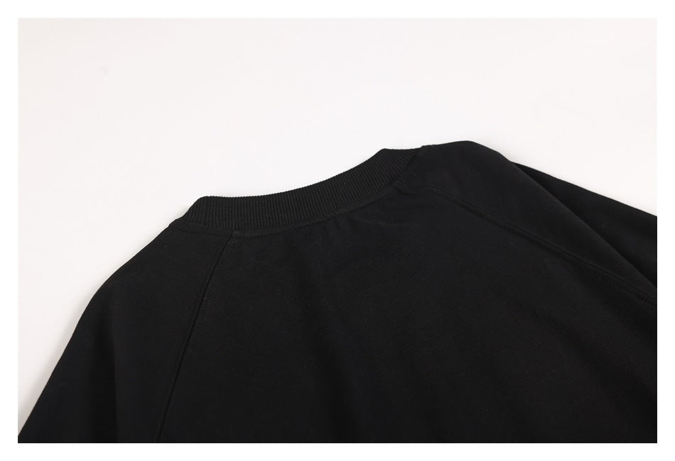 Close-up of the black sweatshirt's back neckline and shoulder seams.