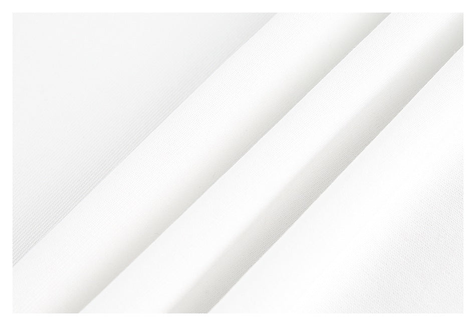 Close-up of white fabric in diagonal folds, showing its fine surface texture.