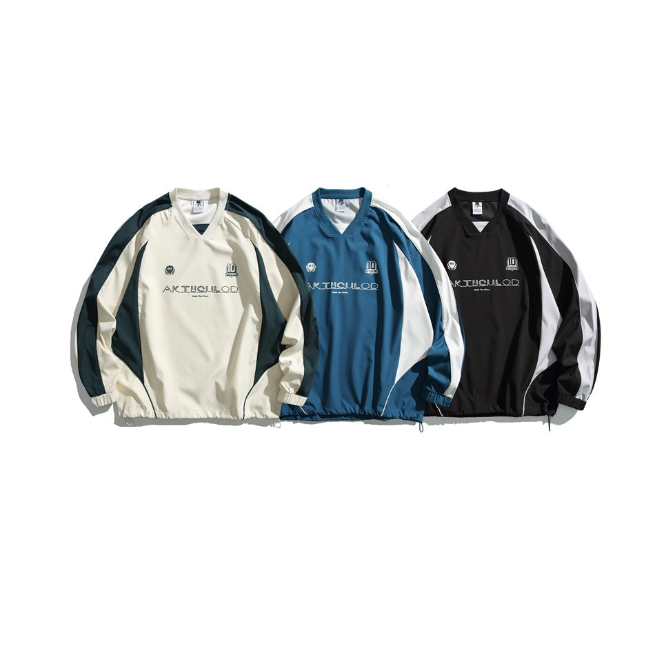 Three V-neck pullovers shown together in cream with dark green panels, blue with white panels, and black with gray panels.