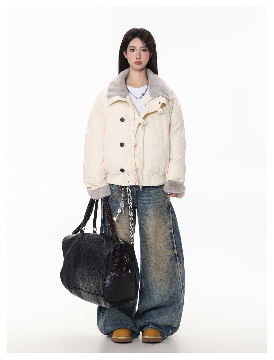 Model wearing the cream jacket with gray fleece-like collar and cuffs, white tee, wide-leg jeans and a black handbag