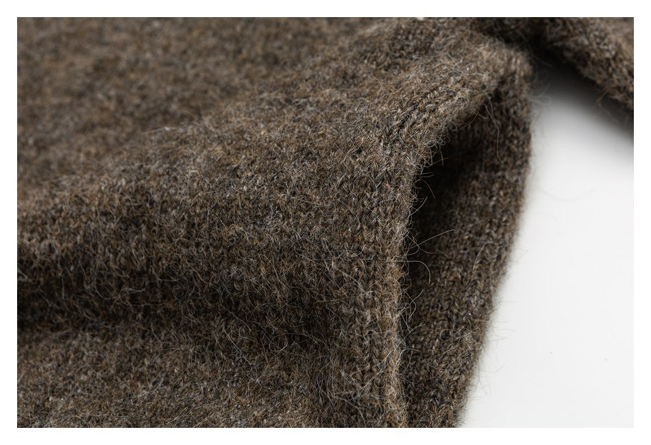 Close-up of a thick edge on brown fuzzy knit fabric against a white background.