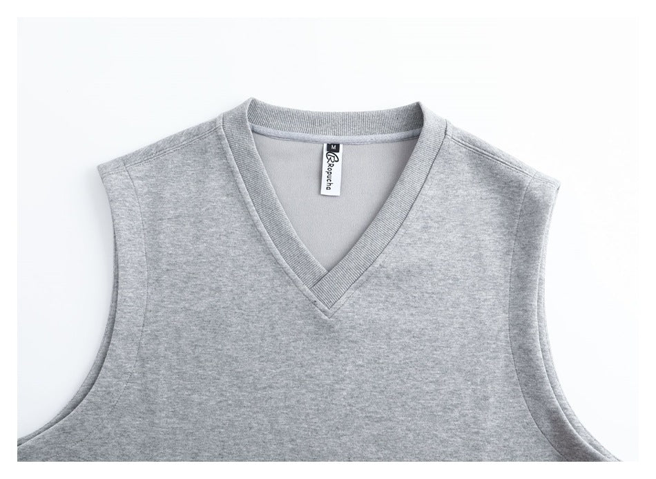 Close front view of a light gray sleeveless vest, showing its ribbed V-neck and inner neck label.